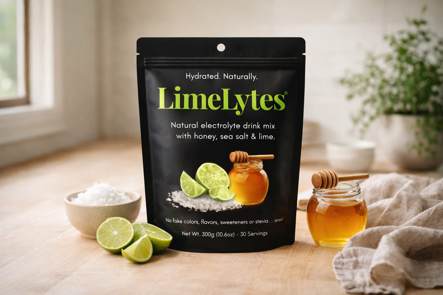 LimeLytes natural electrolyte drink mix package on a wooden surface with limes and honey.